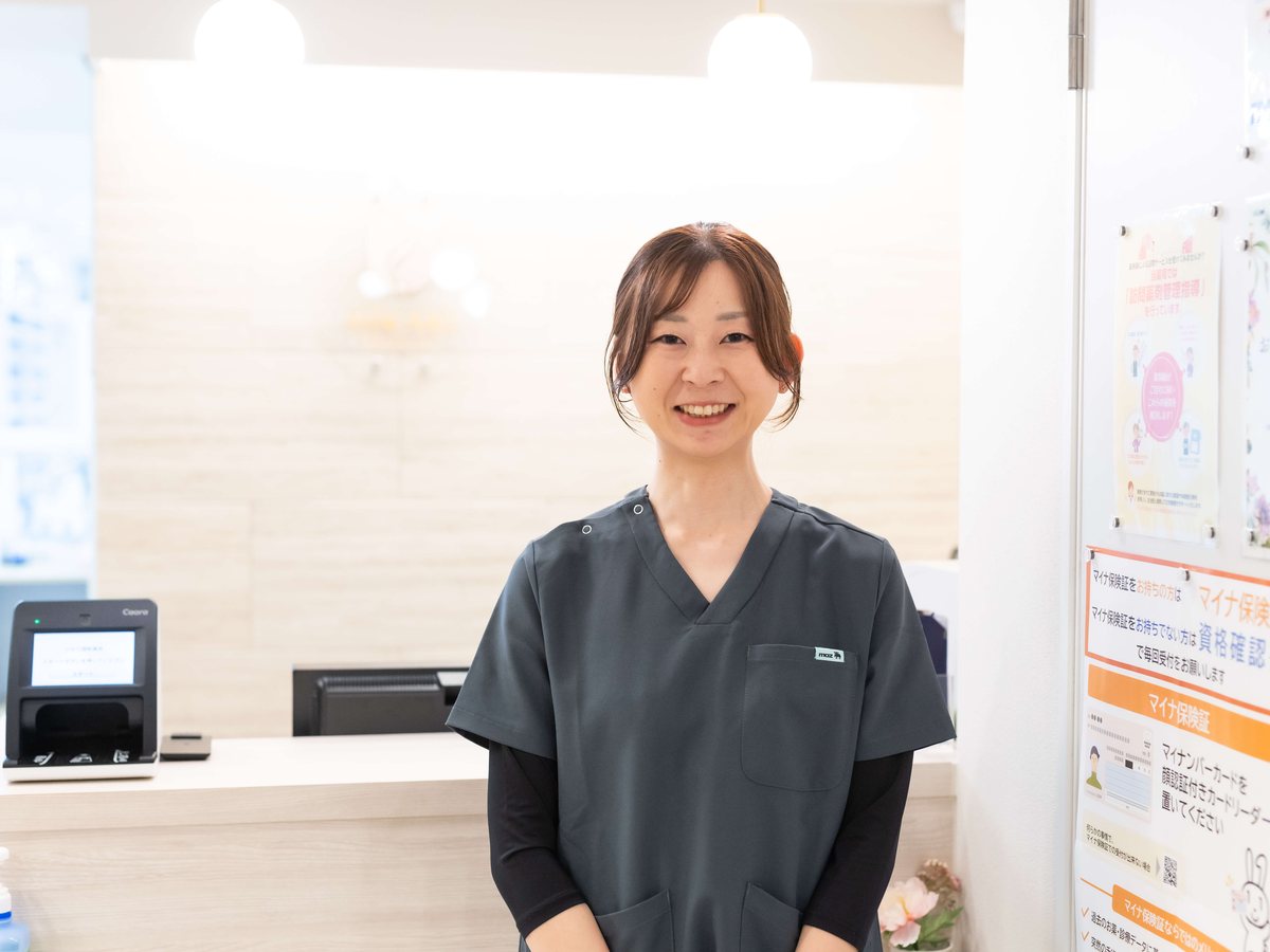 ひかり調剤薬局の受付に立つスタッフ